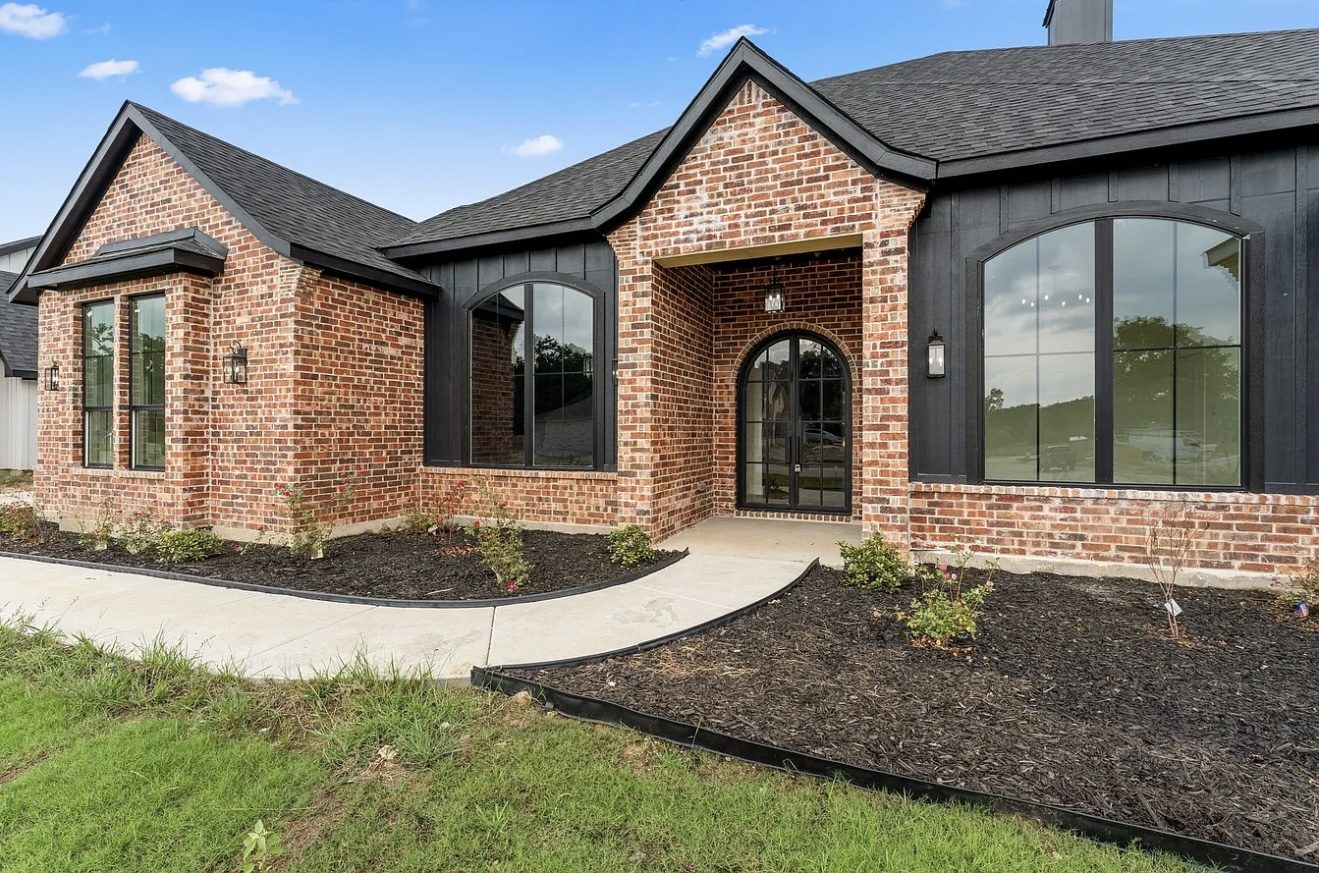 Custom brick home with arched entry