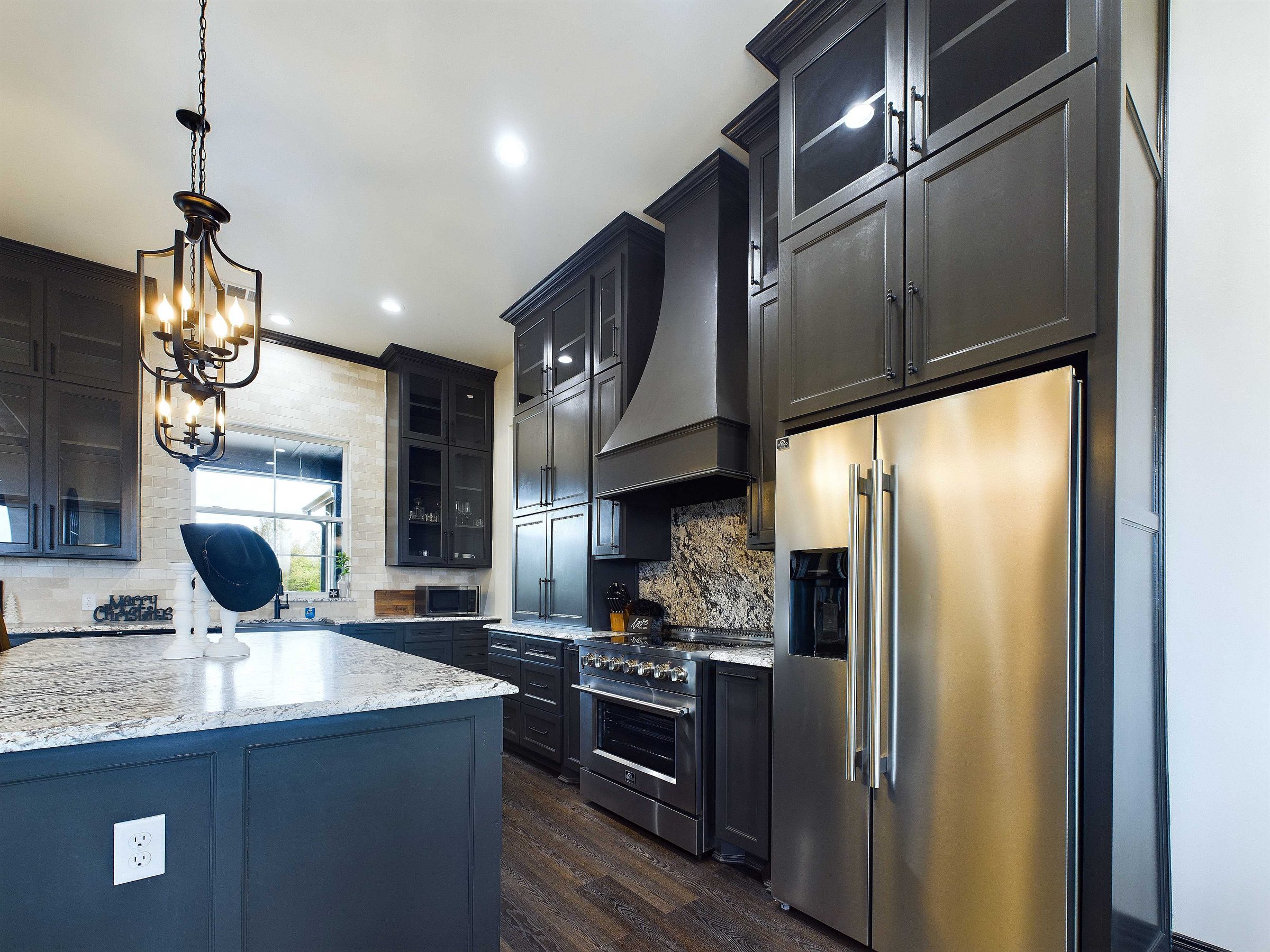 Custom kitchen with stained cabinetry and granite island