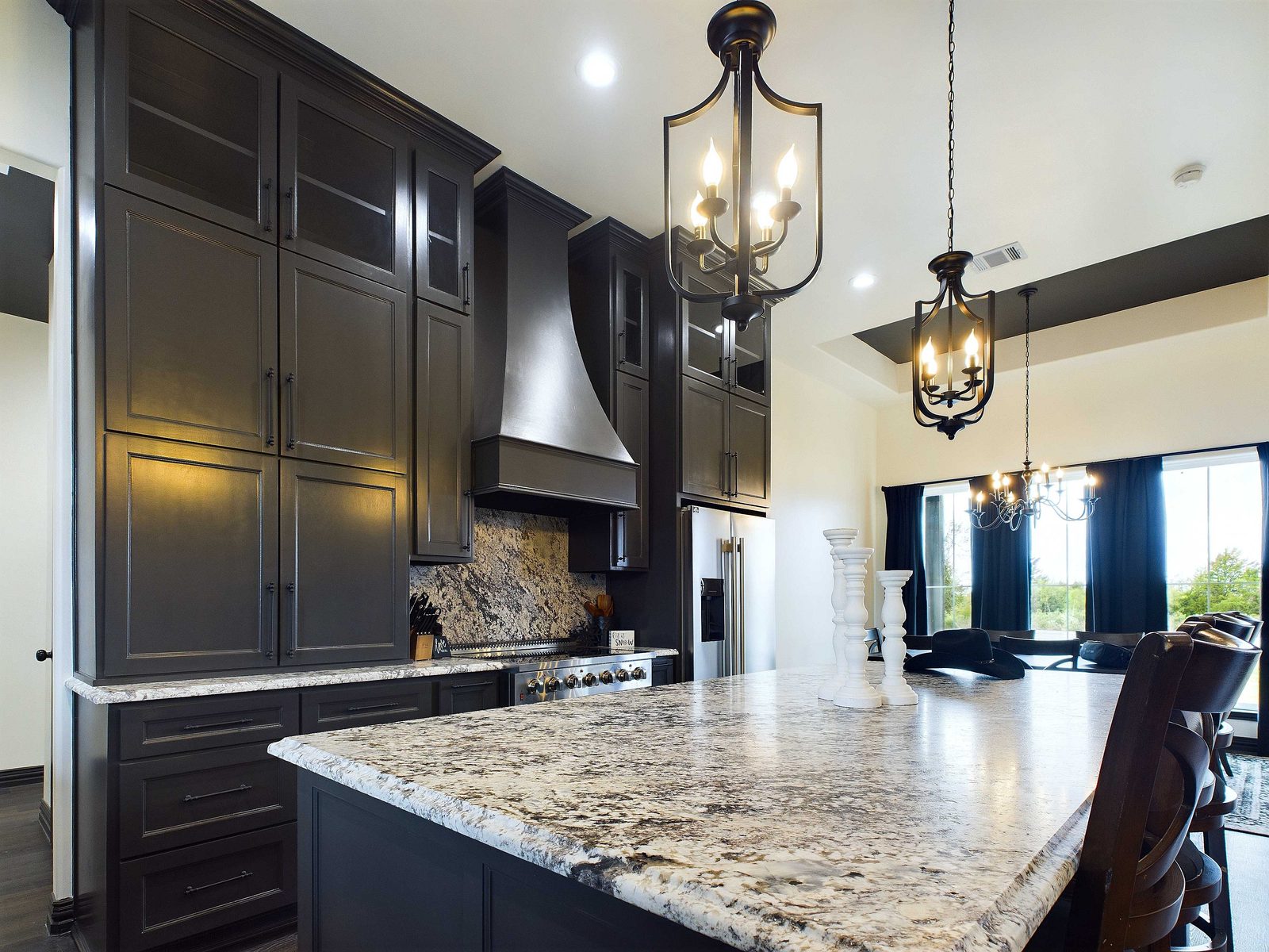 Dark stained cabinetry with granite island
